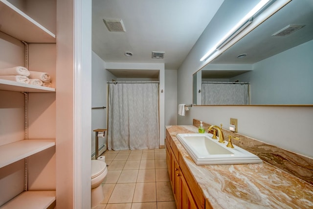 bathroom with tile patterned floors, vanity, and toilet