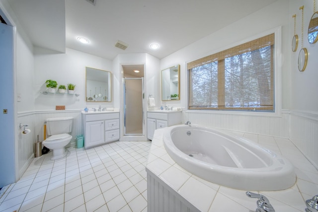 full bathroom featuring toilet, vanity, tile patterned floors, and plus walk in shower