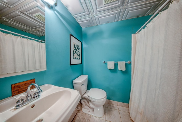 bathroom featuring sink, toilet, and tile patterned floors