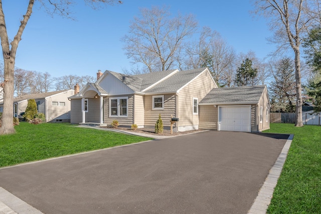 view of front of house with a front yard and a garage