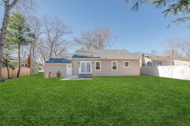 rear view of house with a lawn