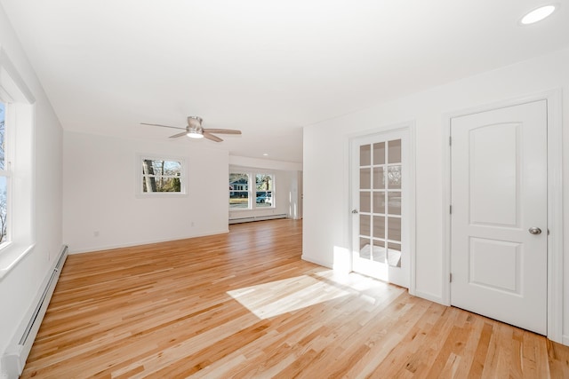 unfurnished room featuring ceiling fan, light hardwood / wood-style flooring, and a baseboard radiator