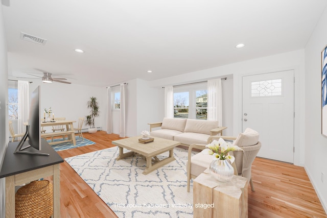 living room with ceiling fan and light wood-type flooring