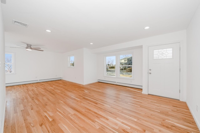 entrance foyer featuring a baseboard heating unit, ceiling fan, and light hardwood / wood-style flooring