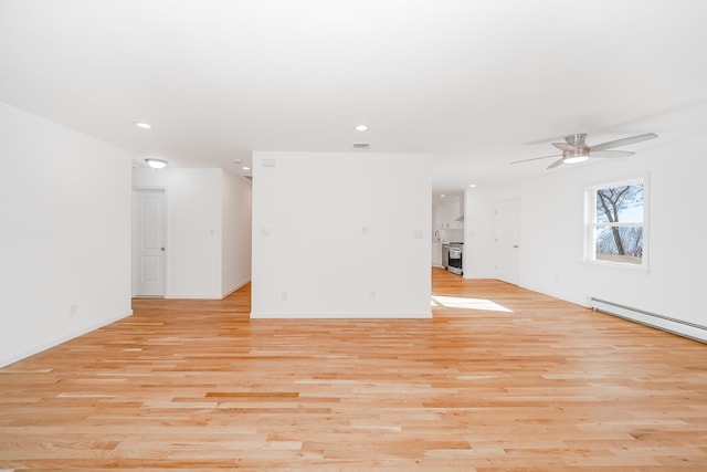 spare room with light hardwood / wood-style floors, ceiling fan, and a baseboard radiator