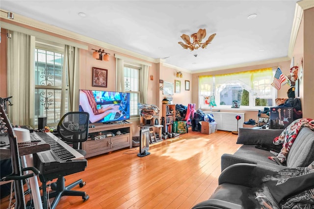 living room with hardwood / wood-style floors and ornamental molding