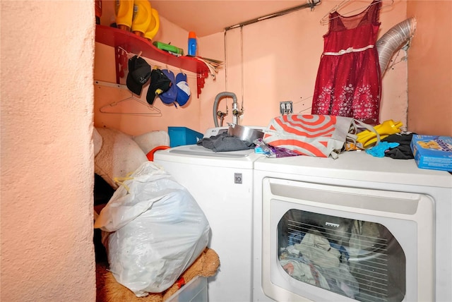 clothes washing area with washing machine and dryer