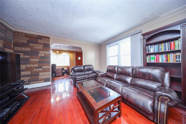 living room with hardwood / wood-style flooring and crown molding