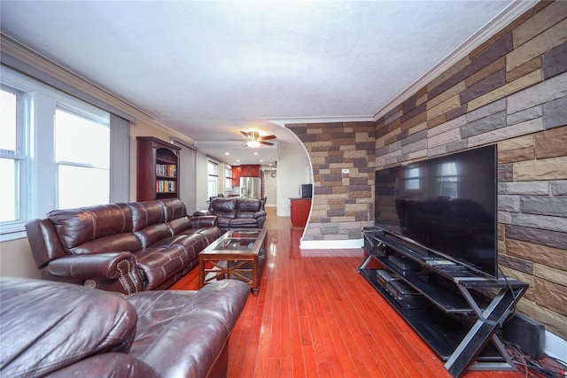 living room featuring hardwood / wood-style flooring, ceiling fan, and ornamental molding