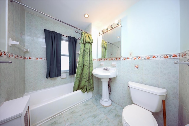 bathroom with tile patterned flooring, shower / bath combination with curtain, tile walls, and toilet