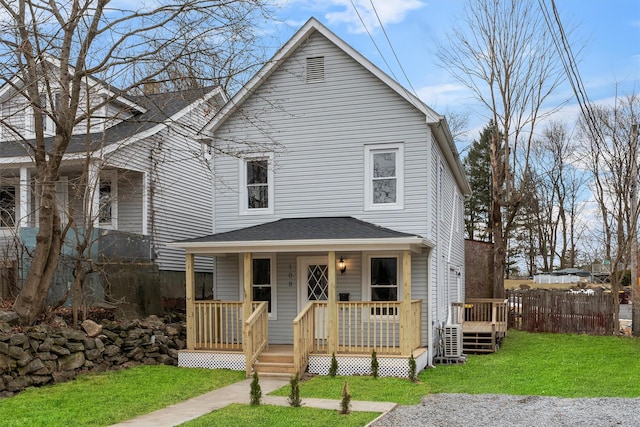 front facade featuring covered porch and a front lawn