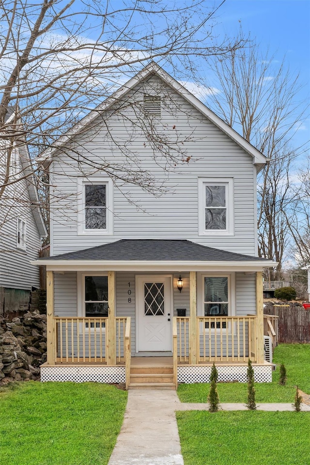 view of front of house with covered porch and a front yard