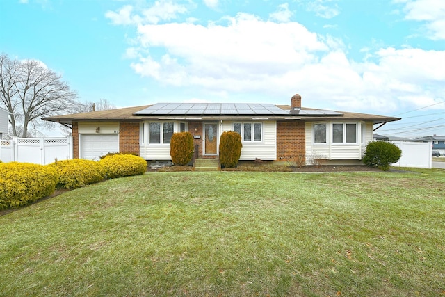 ranch-style house featuring solar panels, a garage, and a front lawn