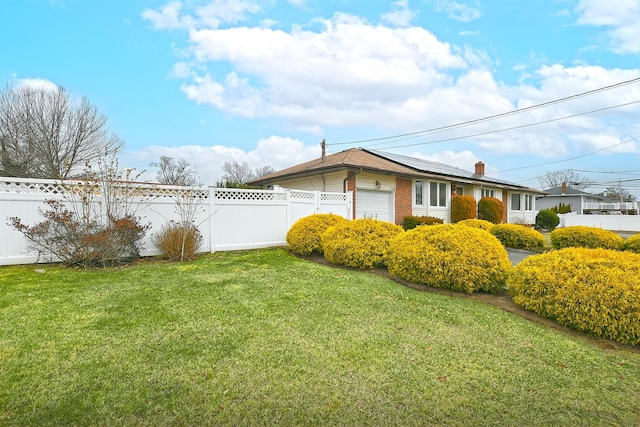 view of side of property with a yard and a garage