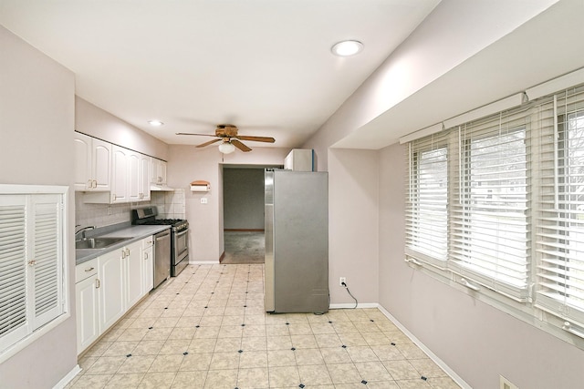 kitchen with sink, decorative backsplash, plenty of natural light, white cabinetry, and stainless steel appliances