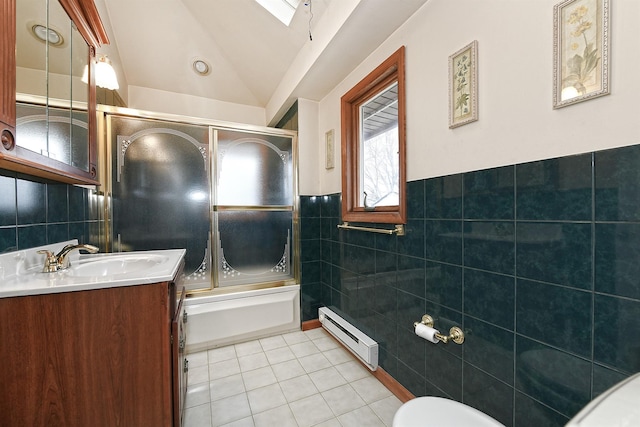 full bathroom featuring tile patterned floors, vaulted ceiling with skylight, bath / shower combo with glass door, a baseboard radiator, and tile walls