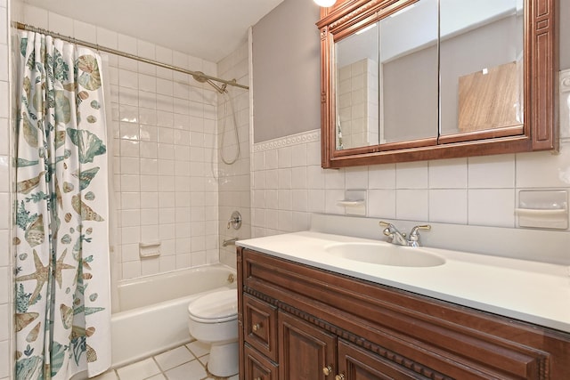 full bathroom featuring tile patterned floors, vanity, shower / tub combo with curtain, tile walls, and toilet