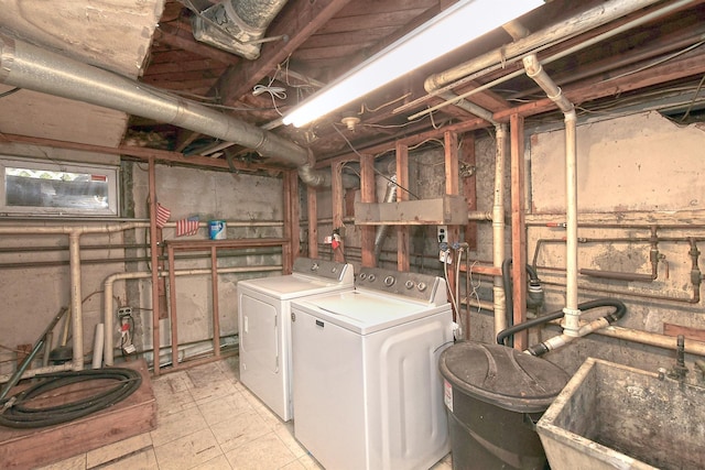 clothes washing area featuring independent washer and dryer and sink