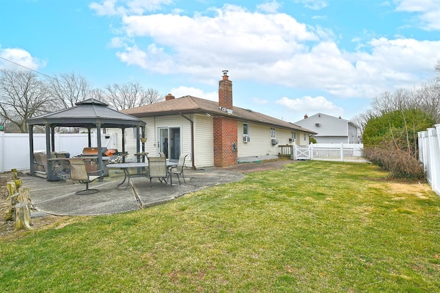 back of house with a gazebo, a lawn, and a patio