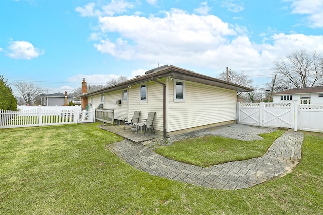 rear view of property featuring a patio and a lawn