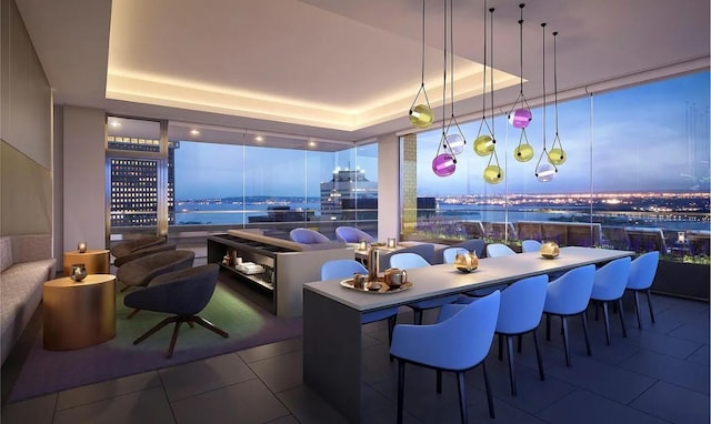 tiled dining space featuring floor to ceiling windows and a tray ceiling