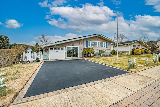 ranch-style house with a garage and a front yard