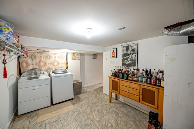 laundry area with independent washer and dryer