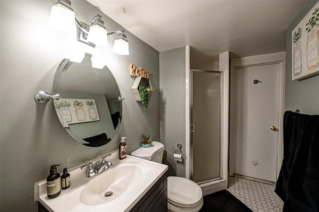 bathroom with toilet, walk in shower, and vanity