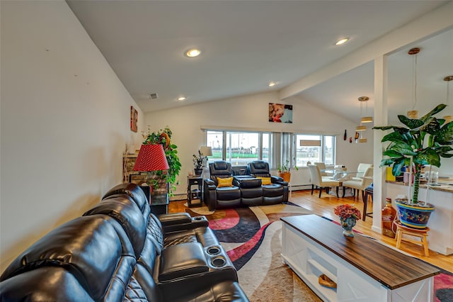 living room featuring vaulted ceiling with beams, a baseboard heating unit, and light hardwood / wood-style floors