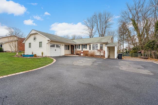 ranch-style home with a front lawn and a garage