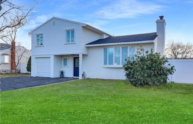 split level home with a front yard and a garage