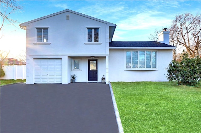 view of front of home featuring a garage and a front yard