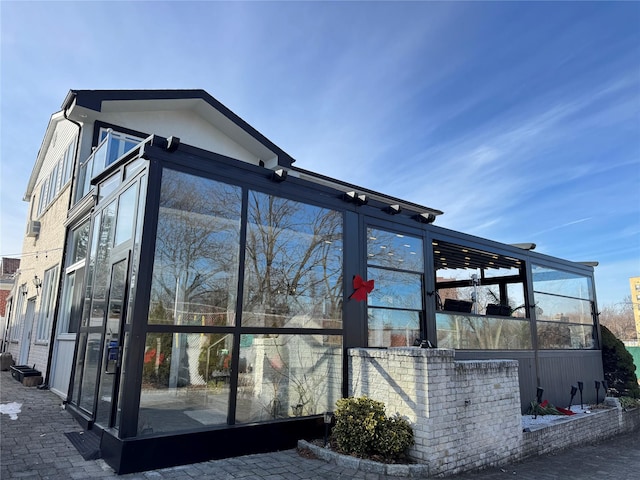 view of side of property featuring a sunroom