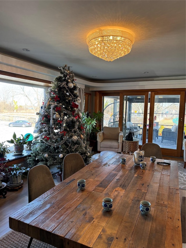 dining area featuring hardwood / wood-style flooring and a notable chandelier