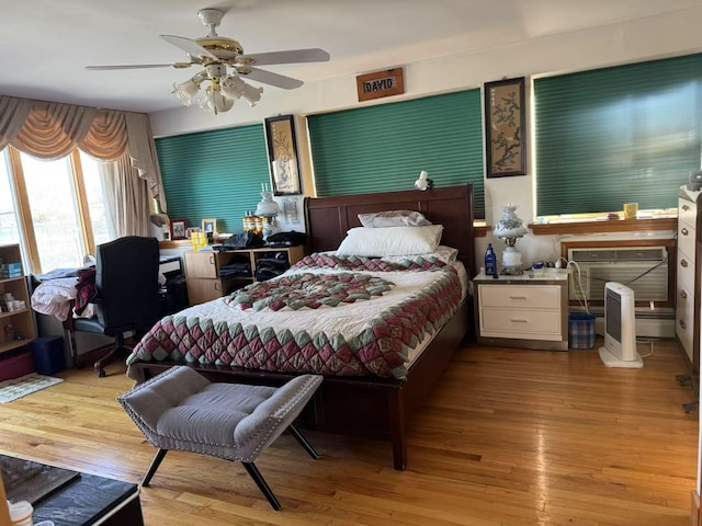 bedroom with ceiling fan and light hardwood / wood-style flooring