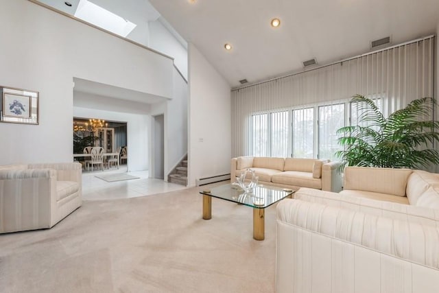 living room featuring high vaulted ceiling, a baseboard heating unit, an inviting chandelier, and light colored carpet