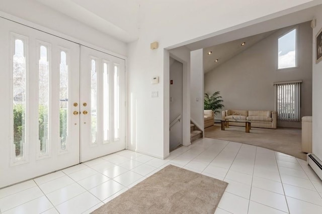 entrance foyer featuring high vaulted ceiling and light tile patterned floors