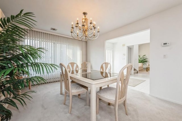 carpeted dining area with a notable chandelier