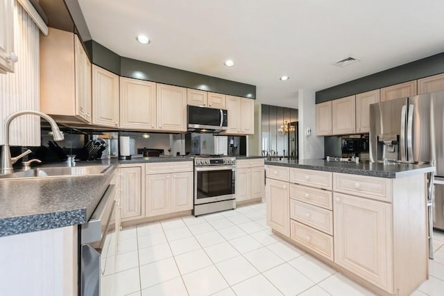 kitchen featuring stainless steel appliances, a center island, sink, light tile patterned flooring, and tasteful backsplash