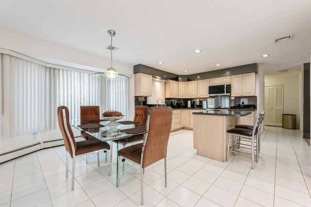 dining area featuring sink and light tile patterned floors