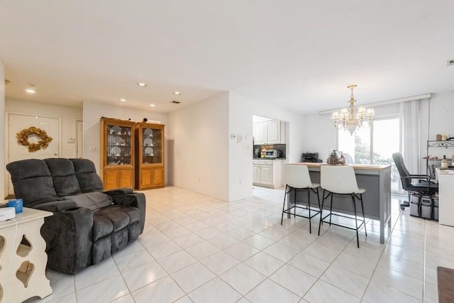 living room featuring an inviting chandelier and light tile patterned floors