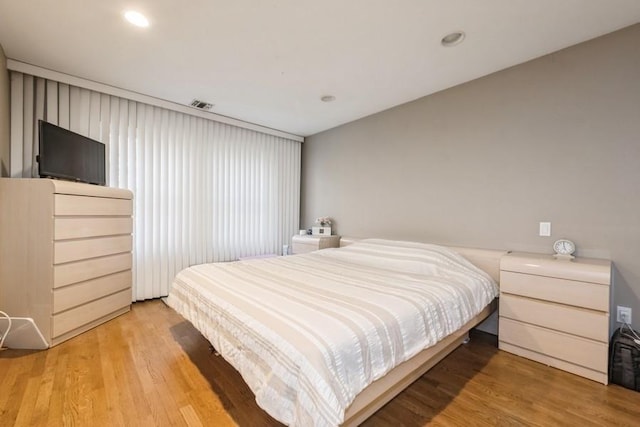 bedroom with hardwood / wood-style flooring