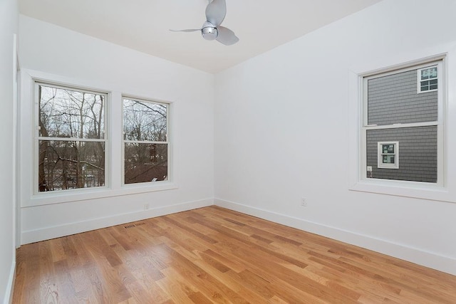 spare room featuring hardwood / wood-style flooring and ceiling fan