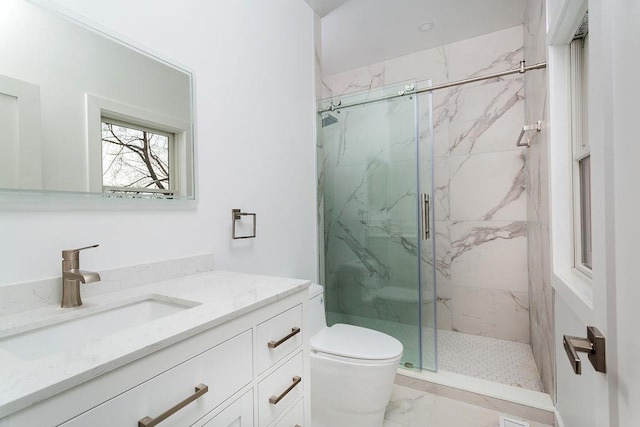 bathroom featuring vanity, toilet, and an enclosed shower