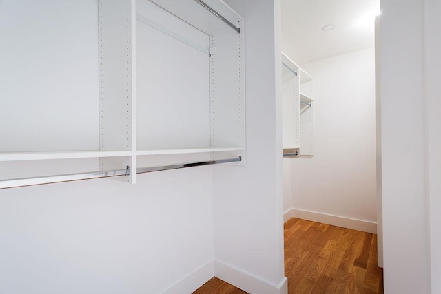 spacious closet featuring hardwood / wood-style floors