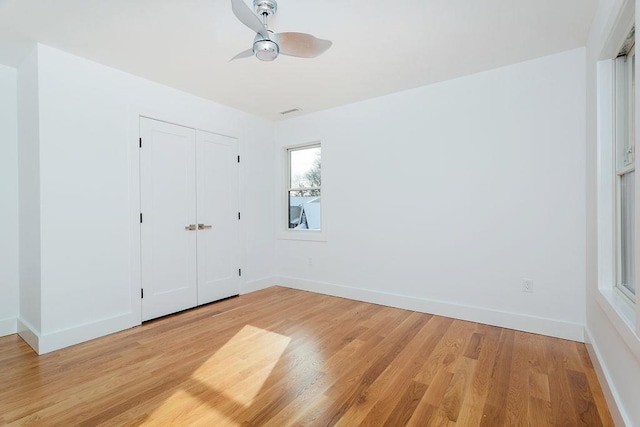 unfurnished bedroom with ceiling fan, light hardwood / wood-style floors, and a closet