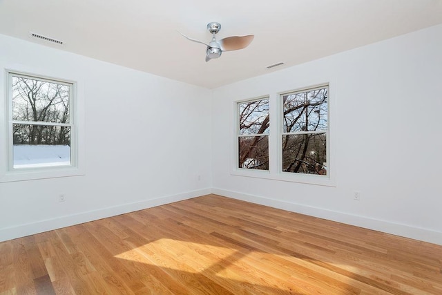 empty room featuring ceiling fan and hardwood / wood-style floors