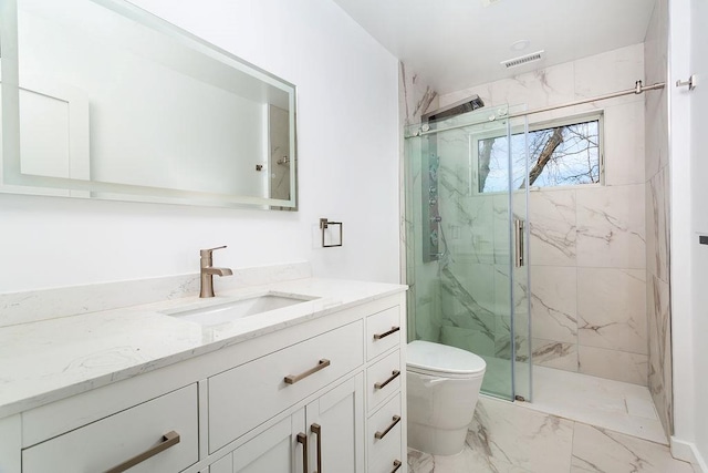 bathroom with vanity, toilet, and a shower with shower door