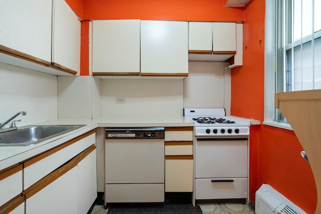 kitchen with sink, white cabinets, and white appliances