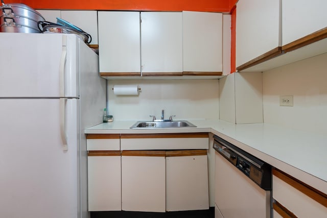 kitchen featuring white cabinetry, white appliances, and sink